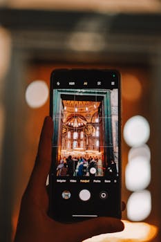 A smartphone captures an iconic Istanbul landmark, blending technology with heritage.