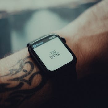 Close-up of a smartwatch displaying 'You Matter' with a tattooed arm in view.