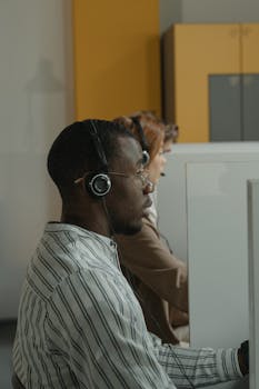 Focused call center agents providing support in a dynamic office environment.