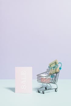 Minimalist image of a shopping cart with money and sale sign, ideal for retail themes.