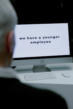 Senior adult facing age discrimination via computer message at workplace.