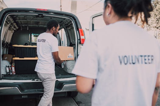 Volunteers loading medicine supplies into a van for donation and distribution.