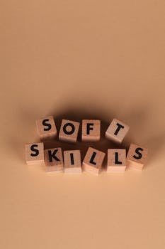 Wooden blocks arranged to spell 'Soft Skills' on a brown background